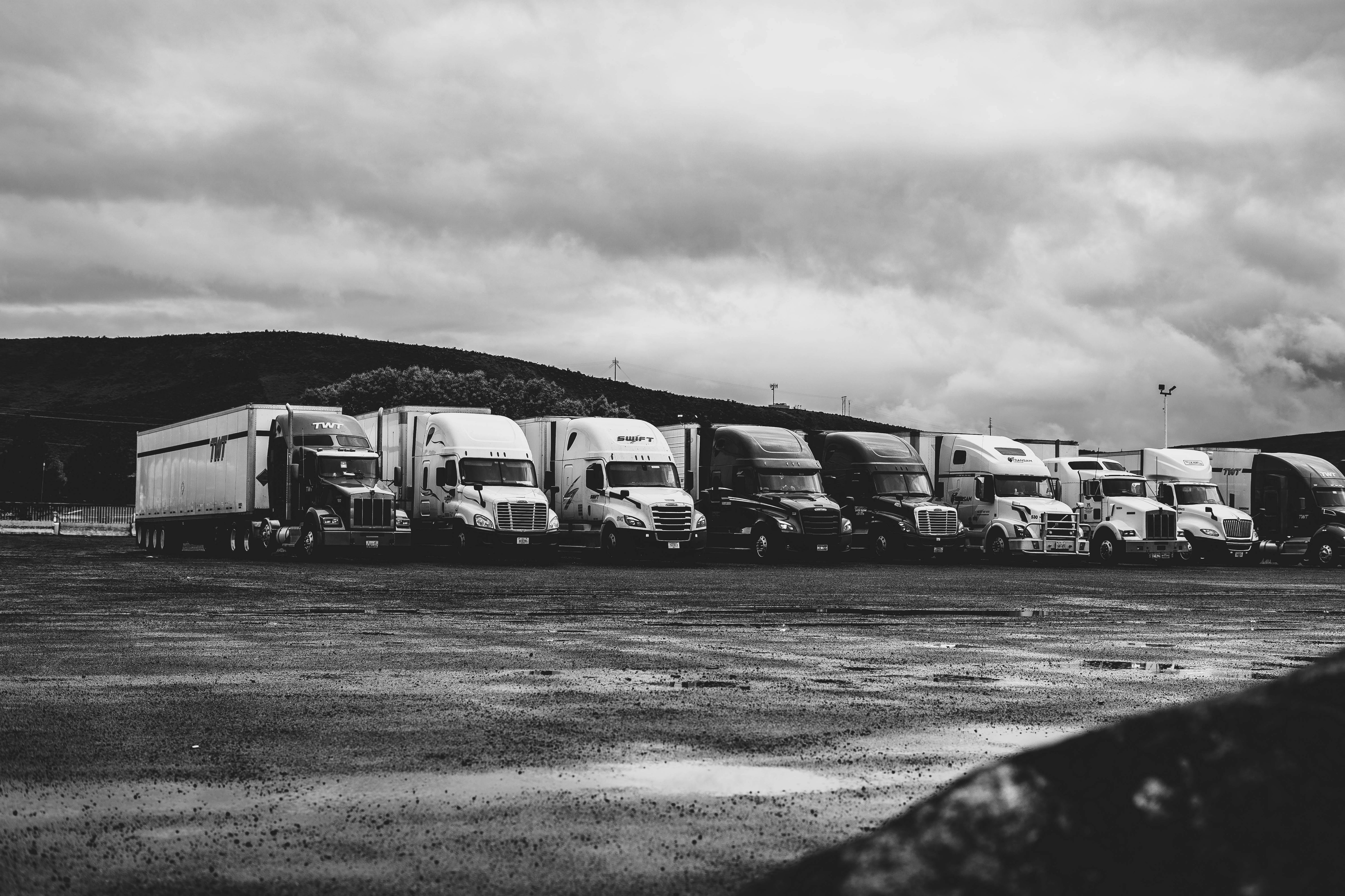 a line of trucks in a parking with sound insulation